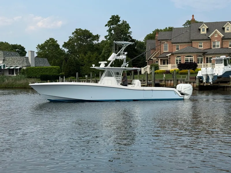 Slide: The Image of 2016 Invincible 39 Open Fisherman boat docked near waterfront homes. - 4