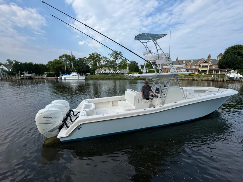 Slide: The Image of 2016 Invincible 39 Open Fisherman boat on calm water, featuring dual Mercury engines. - 6