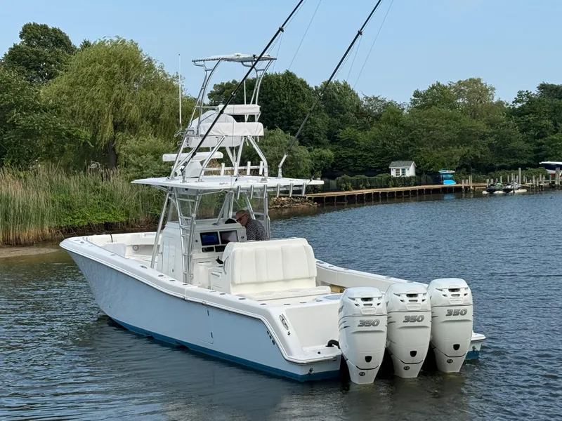 Slide: The Image of 2016 Invincible 39 Open Fisherman boat with triple 350 engines on a calm river. - 7
