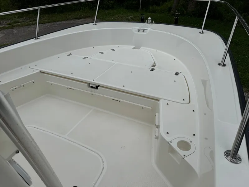 Slide: The Image of 2013 Boston Whaler 210 Montauk boat interior, featuring spacious deck and storage compartments. - 12