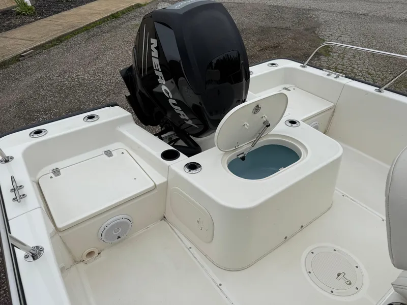 Slide: The Image of 2013 Boston Whaler 210 Montauk boat with Mercury engine and open storage compartments. - 15