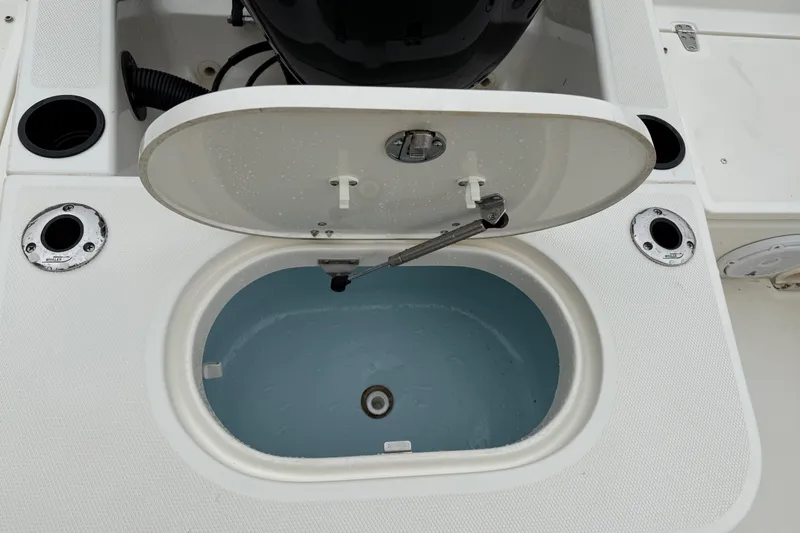 Slide: The Image of Open storage compartment on a 2013 Boston Whaler 210 Montauk boat deck. - 18