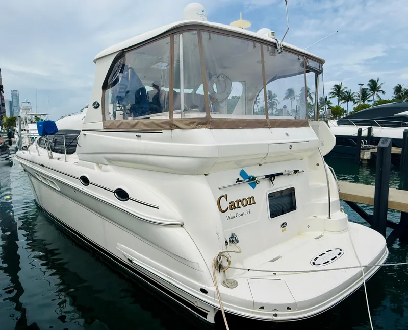 Slide: The Image of 2003 Sea Ray 480 Motor Yacht docked at marina, featuring sleek design and spacious deck. - 11