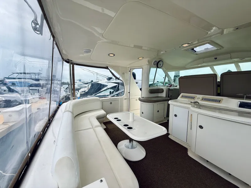 Slide: The Image of 2003 Sea Ray 480 Motor Yacht interior with white seating and modern amenities. - 14