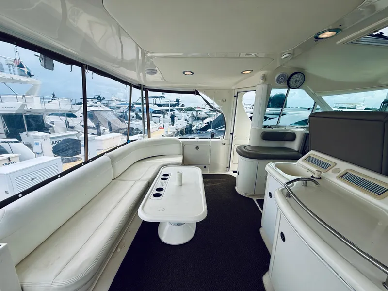 Slide: The Image of Luxurious interior of 2003 Sea Ray 480 Motor Yacht with white seating and modern amenities. - 18