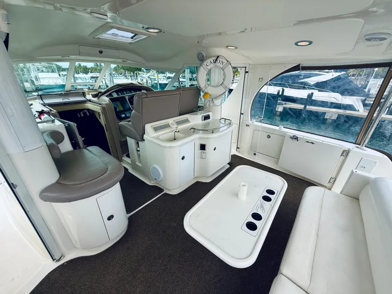 Slide: The Image of Interior of 2003 Sea Ray 480 Motor Yacht with seating and helm, docked at marina. - 20