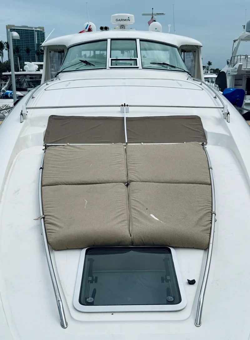 Slide: The Image of 2003 Sea Ray 480 Motor Yacht with cushioned sun deck and hatch, docked at marina. - 38