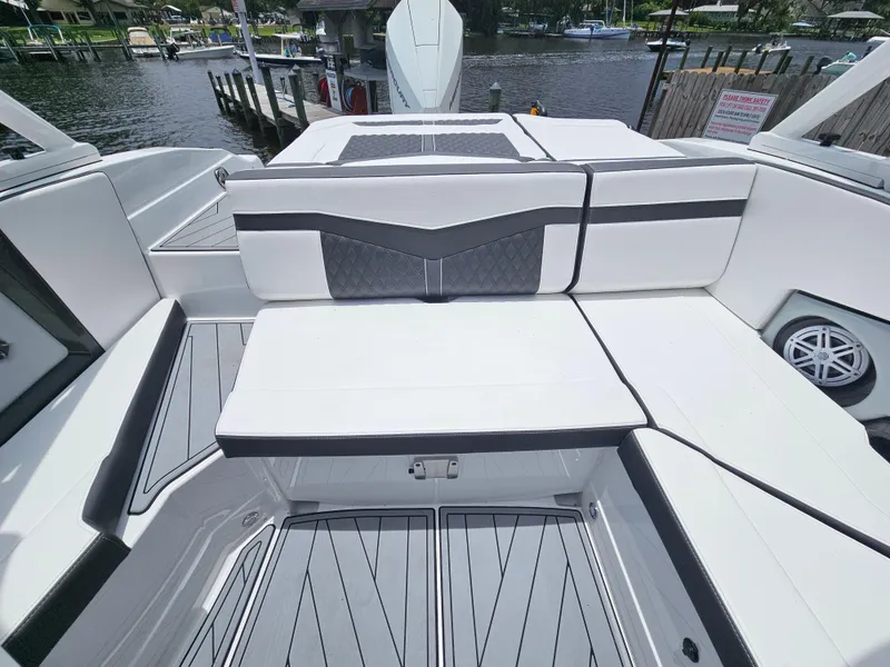 Slide: The Image of 2025 Monterey 235SS boat interior with sleek white seating and modern design. - 16