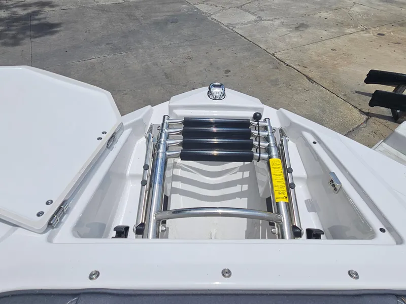 Slide: The Image of 2025 Monterey 235SS boat with open bow storage and ladder, docked on concrete surface. - 20