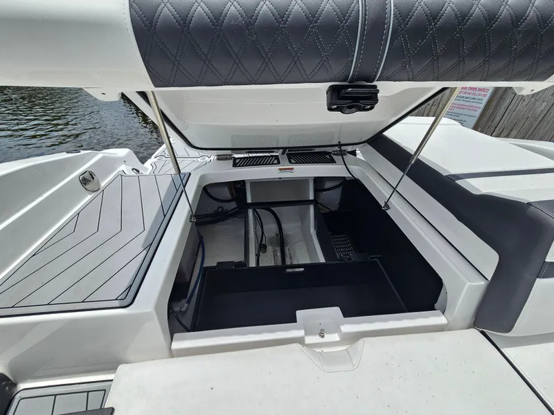 Slide: The Image of 2025 Monterey 235SS boat with open storage compartment, featuring sleek design and modern upholstery. - 25
