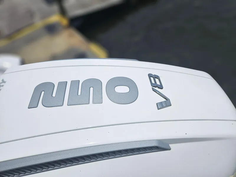 Slide: The Image of 2025 Monterey 235SS boat engine cover with V8 logo, dockside view. - 4