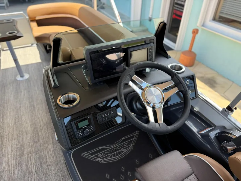 Slide: The Image of 2026 Bennington 24 MSB boat dashboard with steering wheel and modern controls. - 12