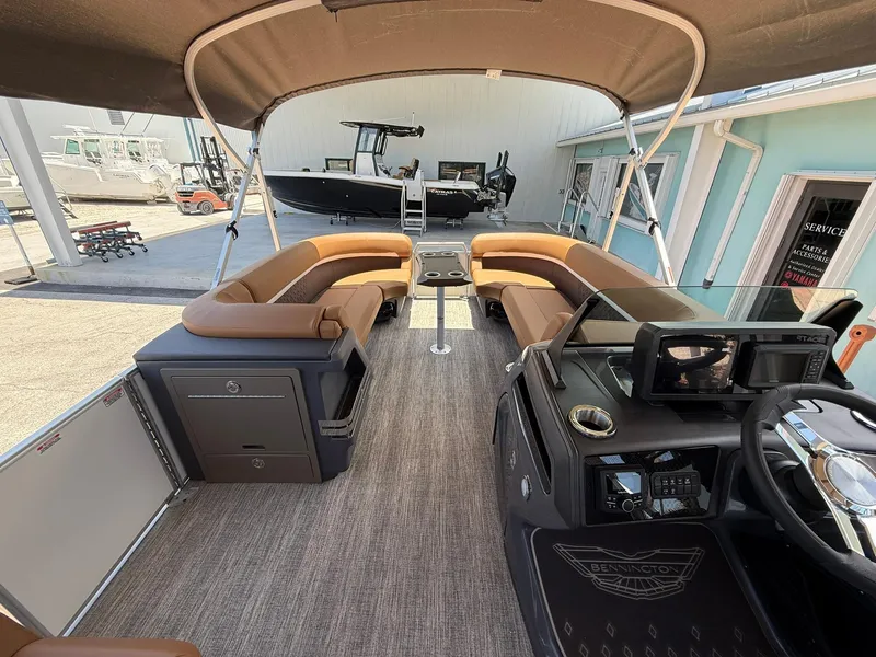 Slide: The Image of 2026 Bennington 24 MSB pontoon boat interior with tan seating and modern dashboard. - 13