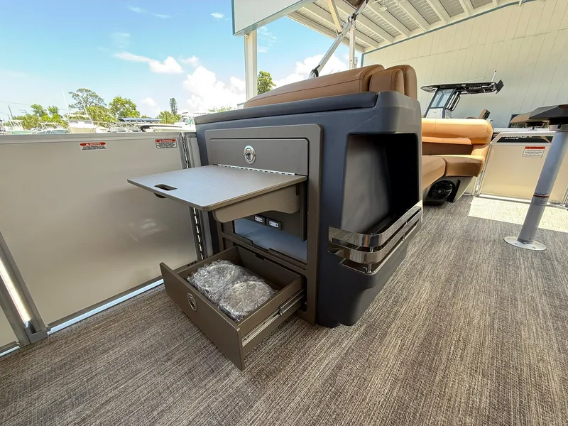 Slide: The Image of 2026 Bennington 24 MSB boat interior with storage compartments and seating. - 16