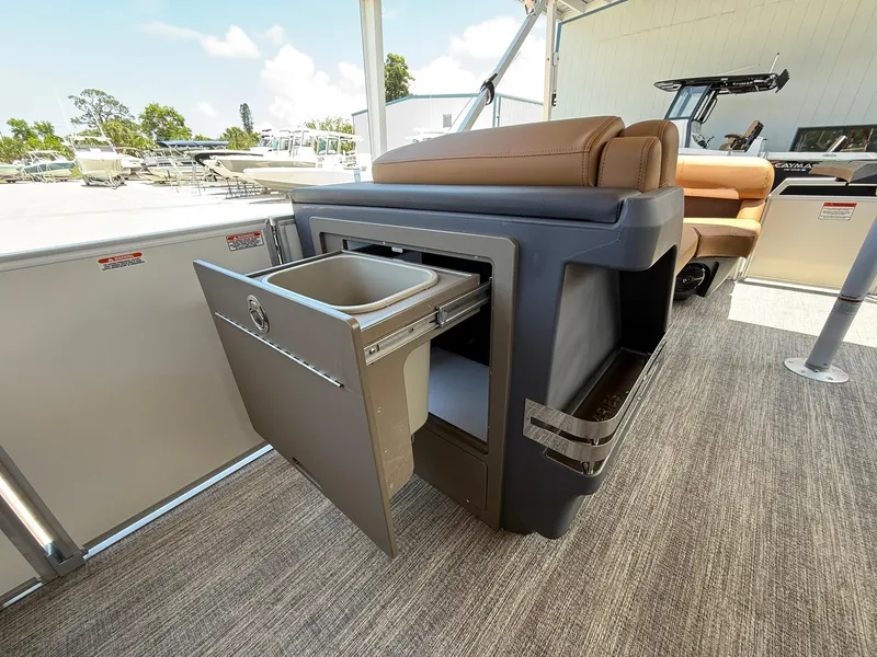 Slide: The Image of 2026 Bennington 24 MSB boat interior with open storage compartment and seating. - 17