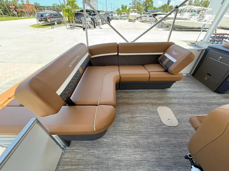 Slide: The Image of Luxurious seating on 2026 Bennington 24 MSB pontoon boat, featuring elegant brown upholstery. - 6
