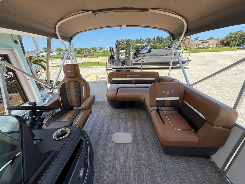 Slide: The Image of 2026 Bennington 24 MSB pontoon boat interior with brown seating and canopy. - 7