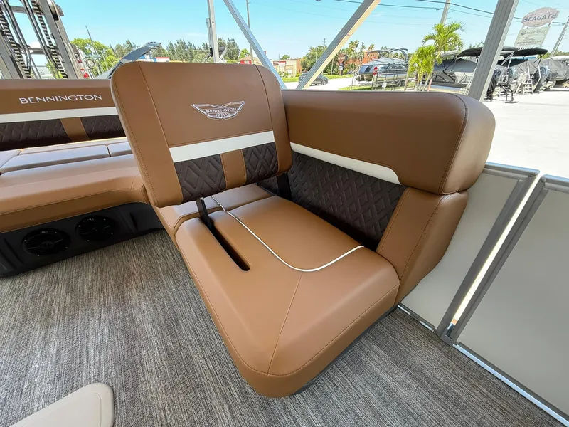 Slide: The Image of Luxurious seating on 2026 Bennington 24 MSB pontoon boat, featuring brown and white upholstery. - 9