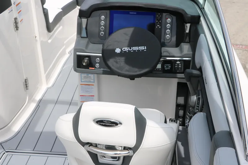 Slide: The Image of 2025 Chaparral 267 SSX boat cockpit with modern steering and dashboard controls. - 15