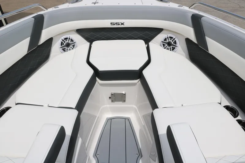 Slide: The Image of 2025 Chaparral 267 SSX boat interior with white and gray seating and speakers. - 19