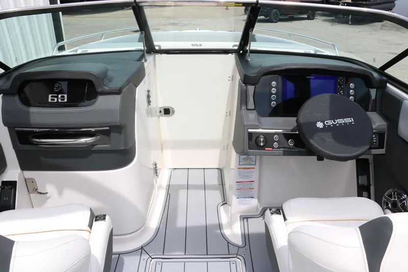 Slide: The Image of 2025 Chaparral 267 SSX boat cockpit with modern dashboard and steering wheel. - 21