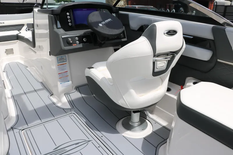 Slide: The Image of 2025 Chaparral 267 SSX boat interior with sleek helm and modern seating. - 27