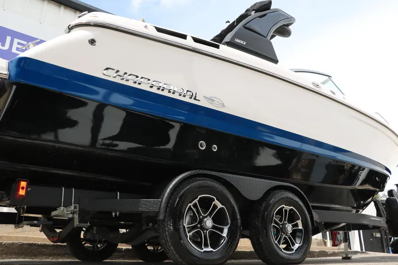 Slide: The Image of 2025 Chaparral 267 SSX boat on trailer, showcasing sleek design and dual axle wheels. - 3