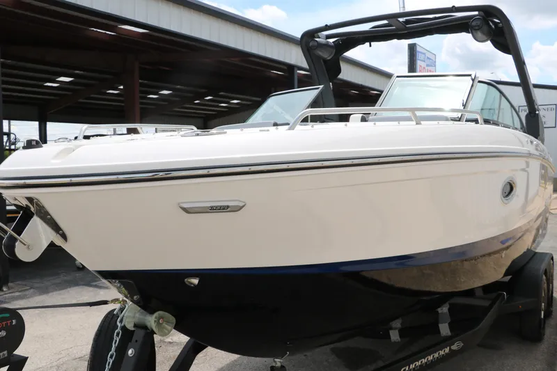 Slide: The Image of 2025 Chaparral 267 SSX boat on trailer, sleek design, outdoor setting. - 7