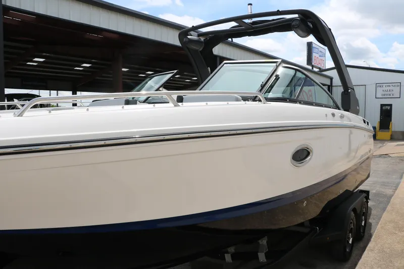 Slide: The Image of 2025 Chaparral 267 SSX boat displayed outdoors, showcasing sleek design and modern features. - 8