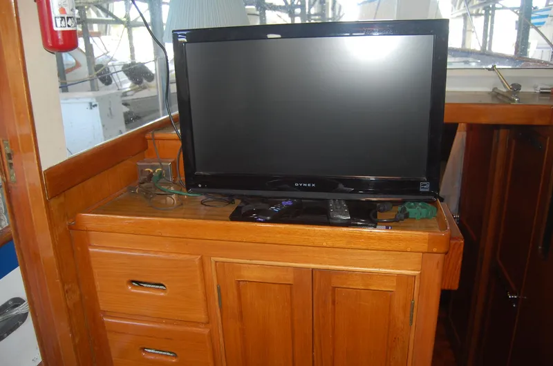 Slide: The Image of Television on wooden cabinet inside 1983 Island Gypsy 36 Quad Cabin boat. - 13
