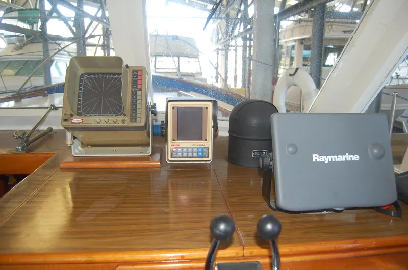 Slide: The Image of 1983 Island Gypsy 36 Quad Cabin helm with navigation equipment and Raymarine display. - 18