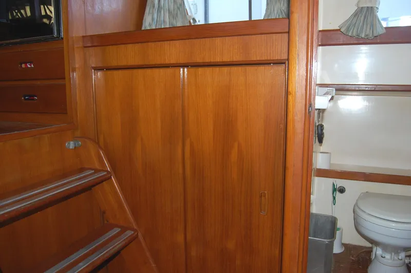 Slide: The Image of 1983 Island Gypsy 36 Quad Cabin interior with wooden stairs and bathroom view. - 21