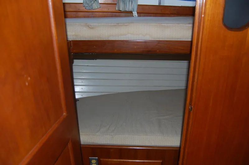 Slide: The Image of 1983 Island Gypsy 36 Quad Cabin interior with wooden bunk beds. - 25