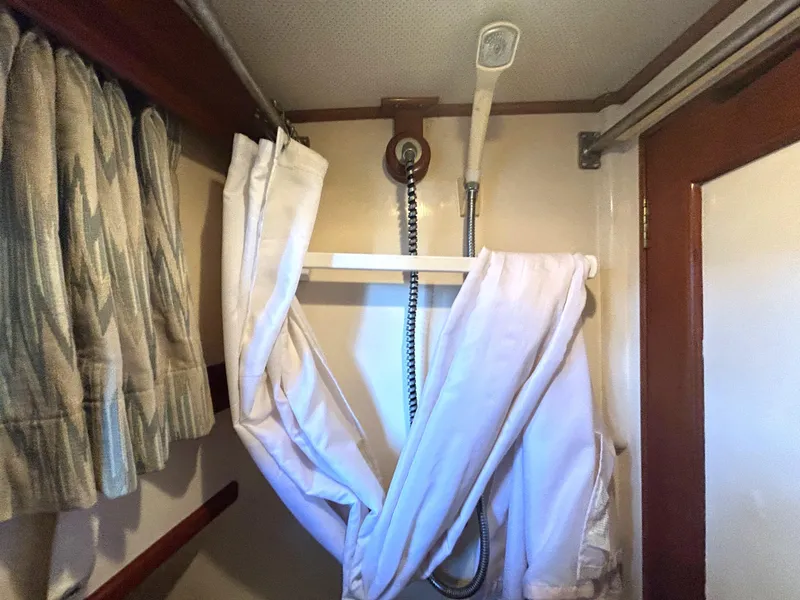 Slide: The Image of Shower area in 1983 Island Gypsy 36 Quad Cabin boat with curtain and showerhead. - 28