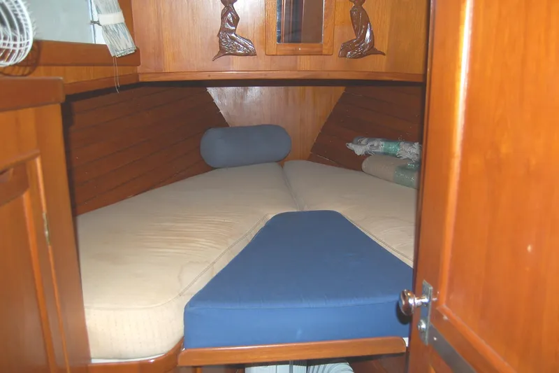 Slide: The Image of Cozy cabin interior of 1983 Island Gypsy 36 Quad, featuring wooden paneling and comfortable bedding. - 3