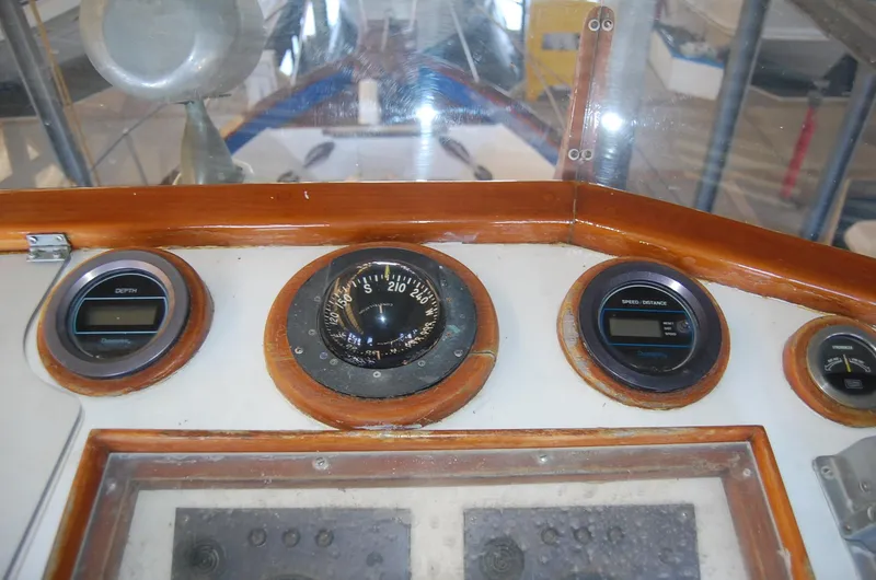 Slide: The Image of Compass and gauges on 1983 Island Gypsy 36 Quad Cabin boat dashboard. - 31