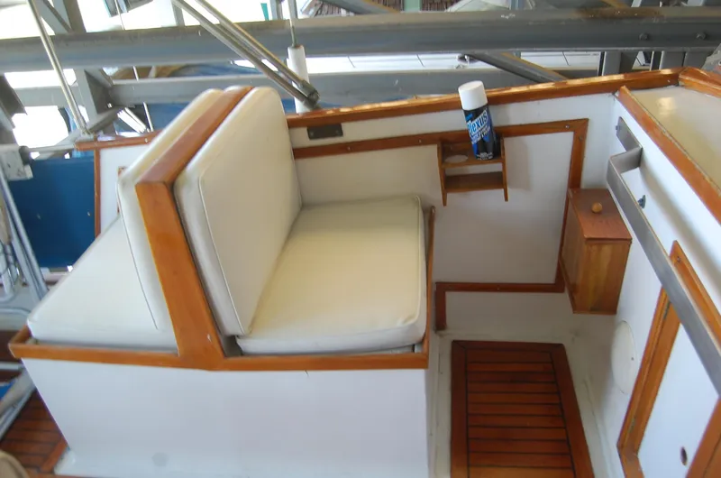 Slide: The Image of 1983 Island Gypsy 36 Quad Cabin interior with white seating and wooden accents. - 32