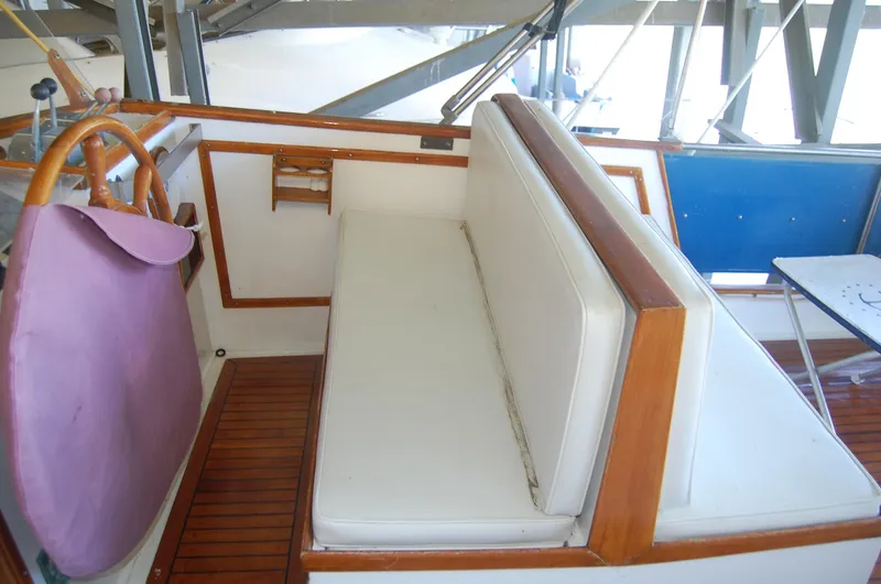 Slide: The Image of 1983 Island Gypsy 36 Quad Cabin interior with white seating and wooden accents. - 33