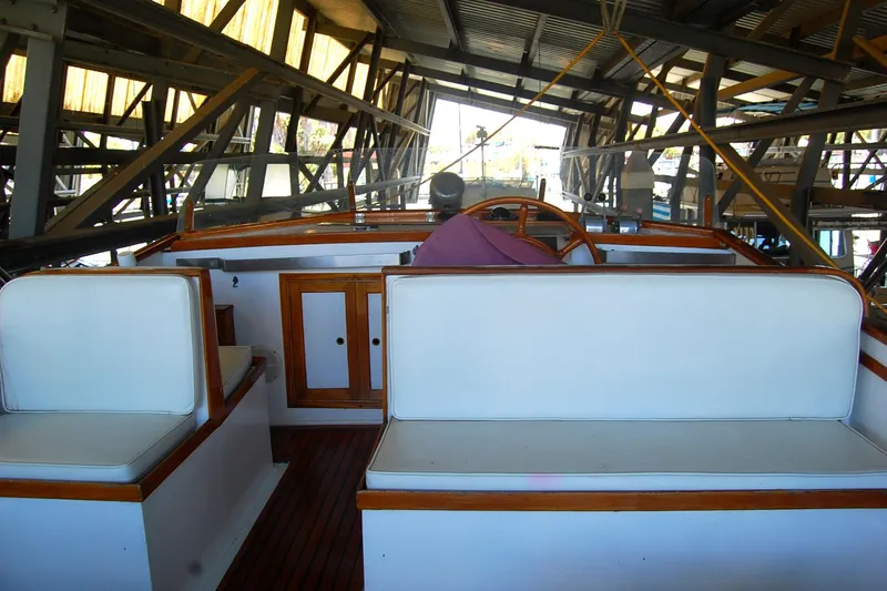 Slide: The Image of 1983 Island Gypsy 36 Quad Cabin interior with white seating and wooden accents. - 34