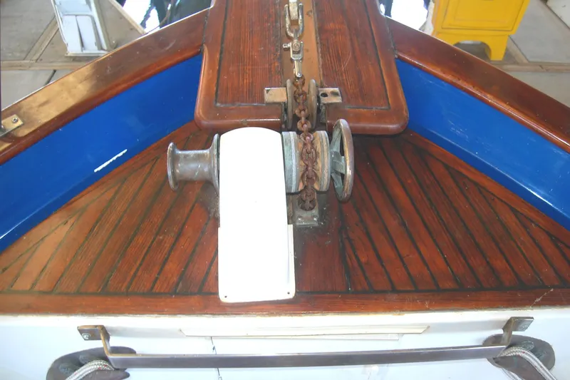 Slide: The Image of Bow of 1983 Island Gypsy 36 Quad Cabin with anchor chain and wooden deck. - 42