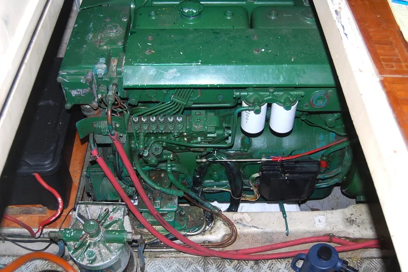 Slide: The Image of Engine compartment of 1983 Island Gypsy 36 Quad Cabin with green machinery and wiring. - 46