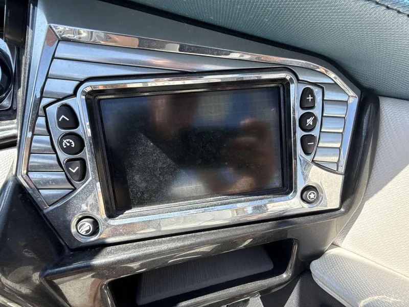 Slide: The Image of 2016 Tigé Z3 boat dashboard with touchscreen and control buttons. - 13
