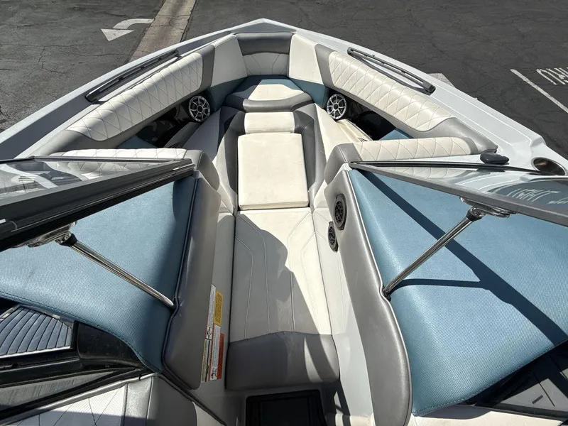 Slide: The Image of 2016 Tigé Z3 boat interior with blue and white seating, speakers, and open bow design. - 21