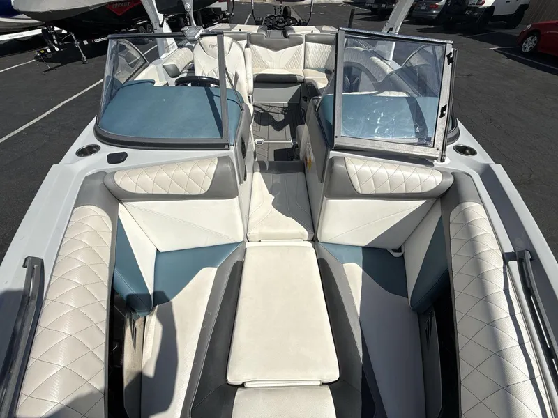 Slide: The Image of 2016 Tigé Z3 boat interior with white and blue seating, open windshield, and spacious layout. - 22