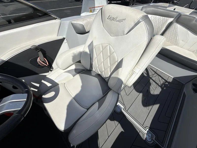 Slide: The Image of 2016 Tigé Z3 boat interior with white leather seating and steering wheel. - 23