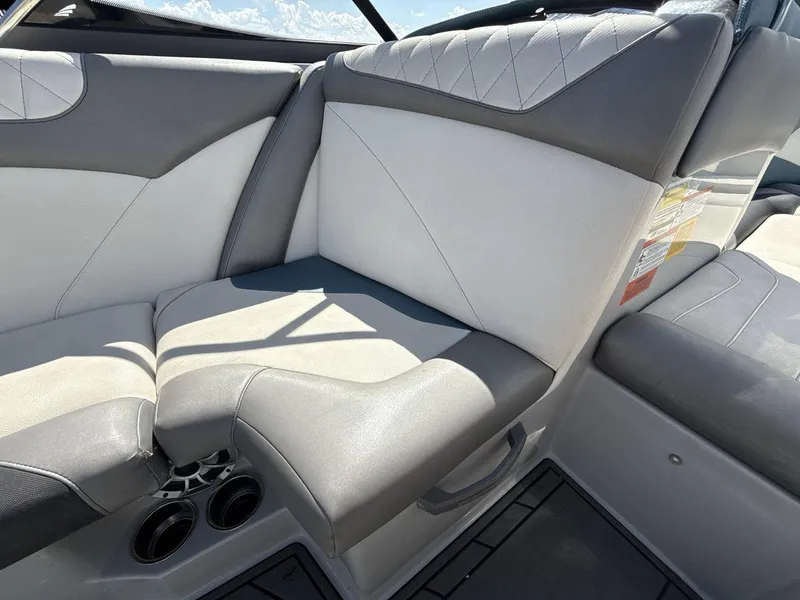 Slide: The Image of 2016 Tigé Z3 boat interior with gray and white seating, cup holders, and sleek design. - 27