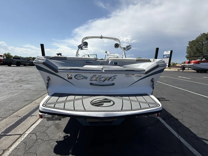 Slide: The Image of 2016 Tigé Z3 boat rear view in parking lot under clear sky. - 4