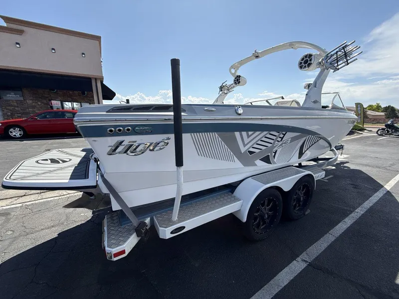 Slide: The Image of 2016 Tigé Z3 boat on trailer, parked outdoors, featuring sleek design and modern graphics. - 5