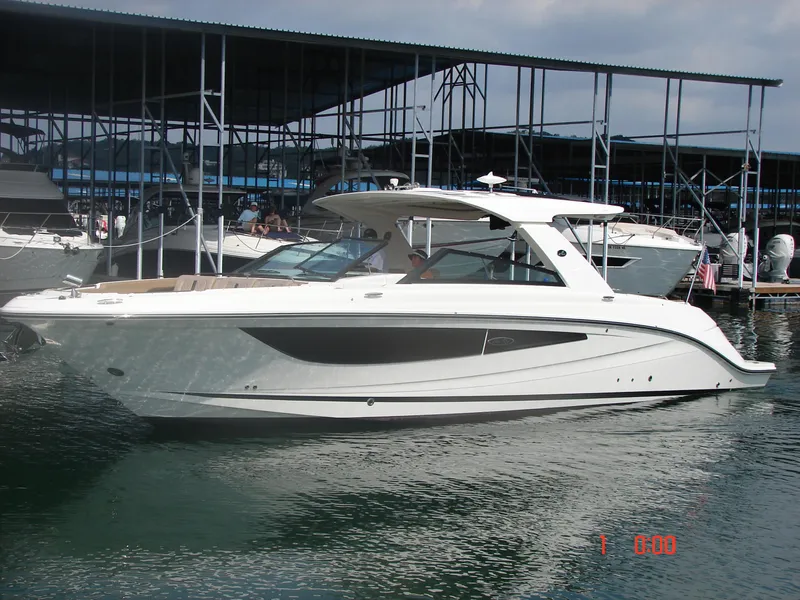 The Image of 2018 Sea Ray SLX 400 boat docked in a marina, side view. - 0