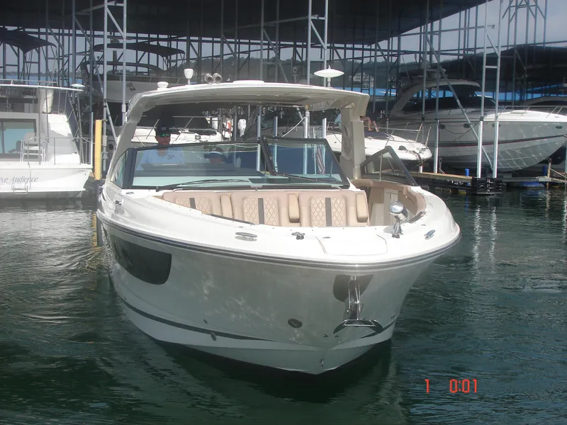 Slide: The Image of 2018 Sea Ray SLX 400 boat docked in a marina, front view. - 18